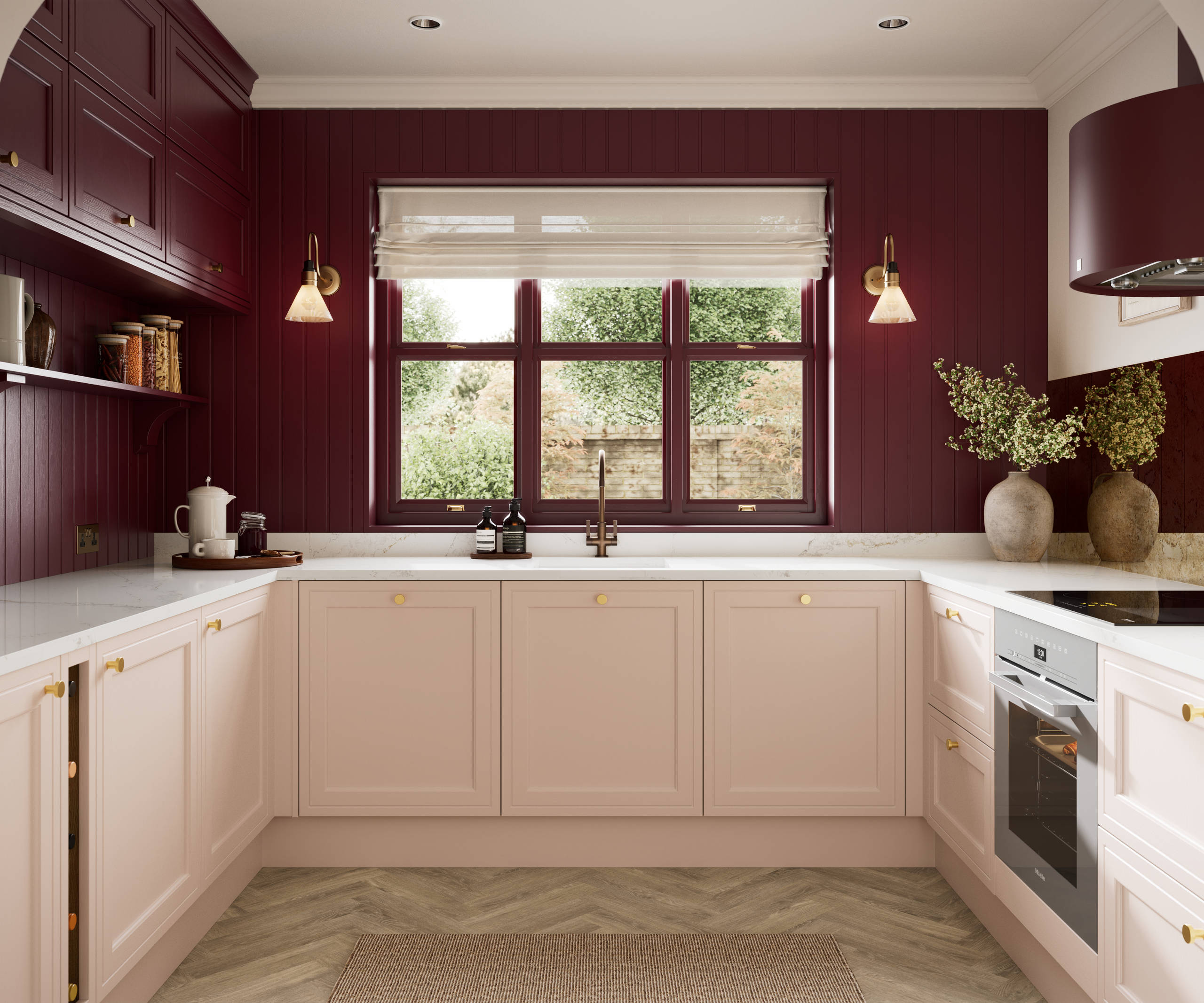 Painted wood grain Shaker style Bewdley kitchen with cabinets in light pink shade Chalk Blush, marbled worktop, brass knobs, red Morello wall-mounted cabinets with matching shelves and wall panel, built- in wine storage.