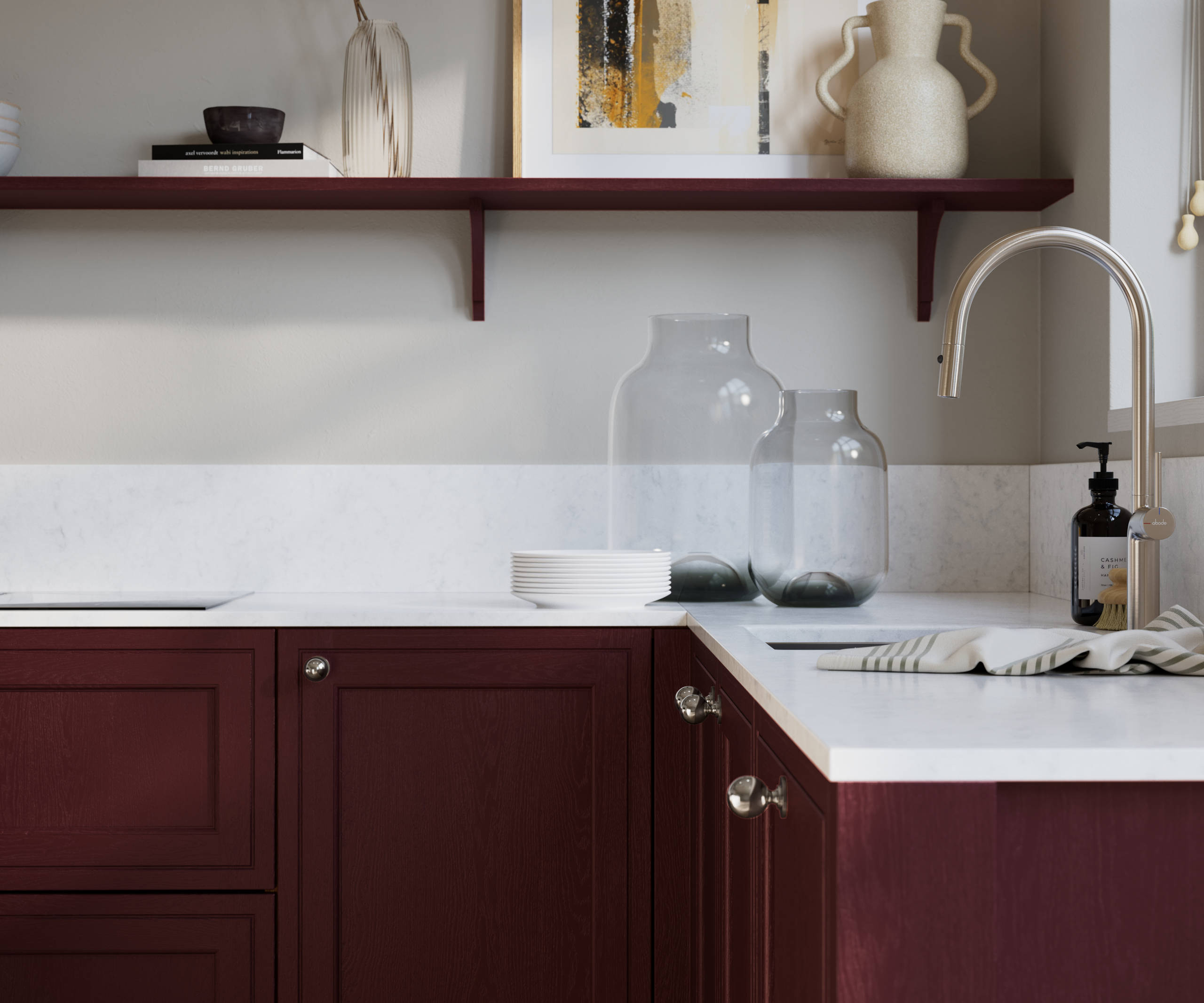 Bewdley Morello painted wood grain Shaker kitchen cabinetry with steel knobs, steel tap, white marbled worktop and matching backsplash, an open shelf on the wall above cabinets with ceramics and a vase of flowers.