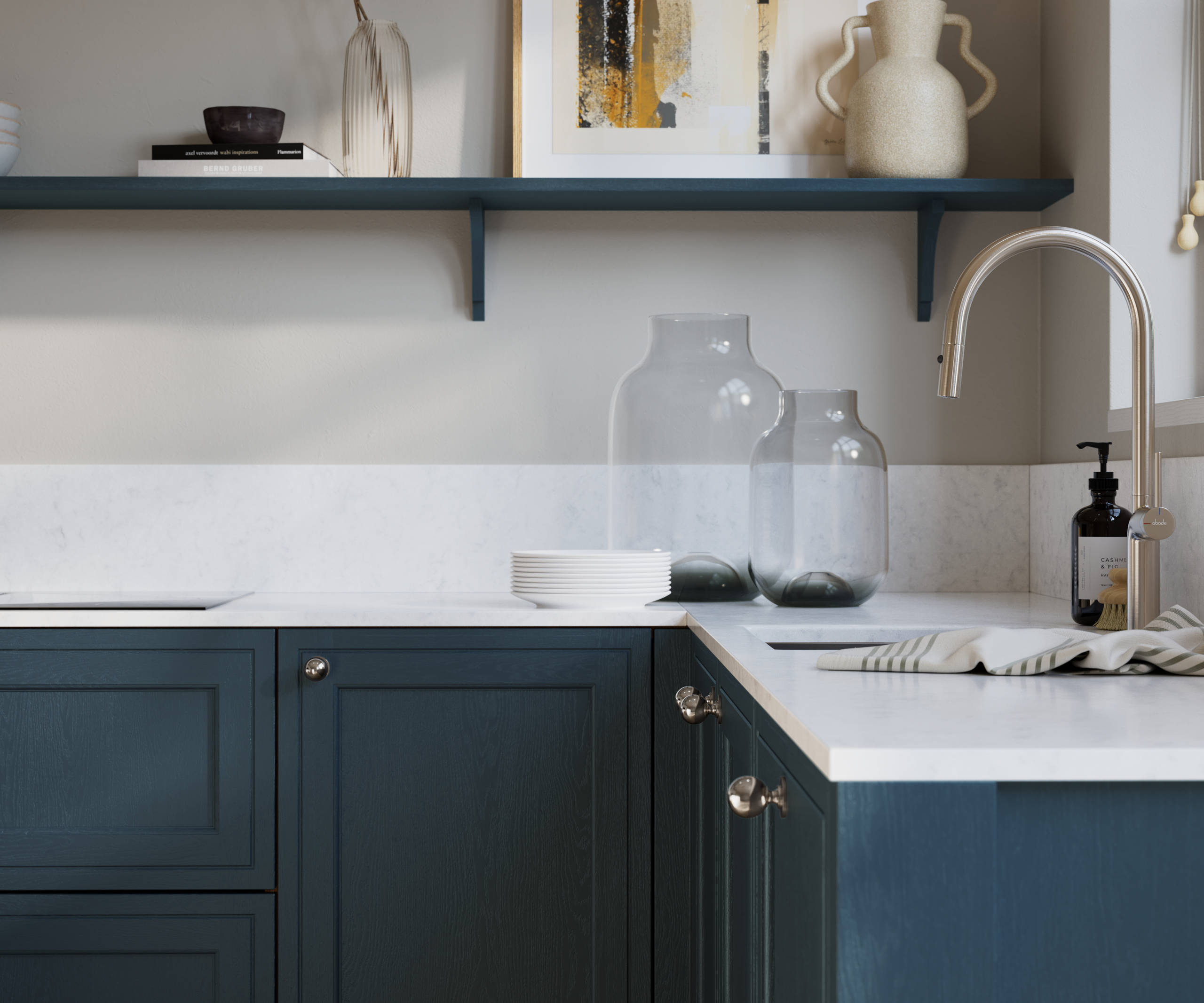 Bewdley Midnight painted wood grain Shaker kitchen cabinetry with steel knobs, steel tap, white marbled worktop and matching backsplash, an open shelf on the wall above cabinets with ceramics and a vase of flowers.