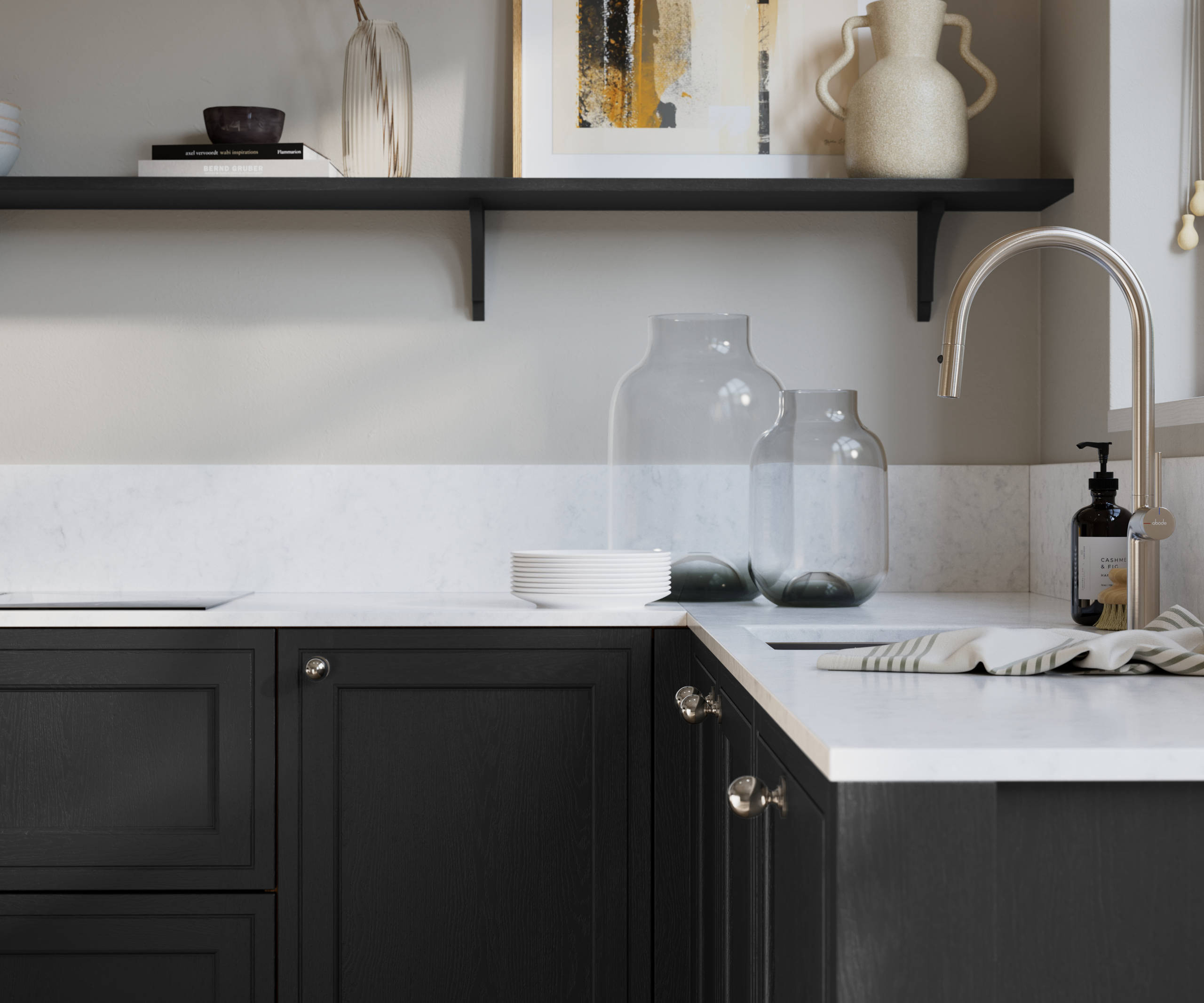 Bewdley Sumi Black painted wood grain Shaker kitchen cabinetry with steel knobs, steel tap, white marbled worktop and matching backsplash, an open shelf on the wall above cabinets with ceramics and a vase of flowers.