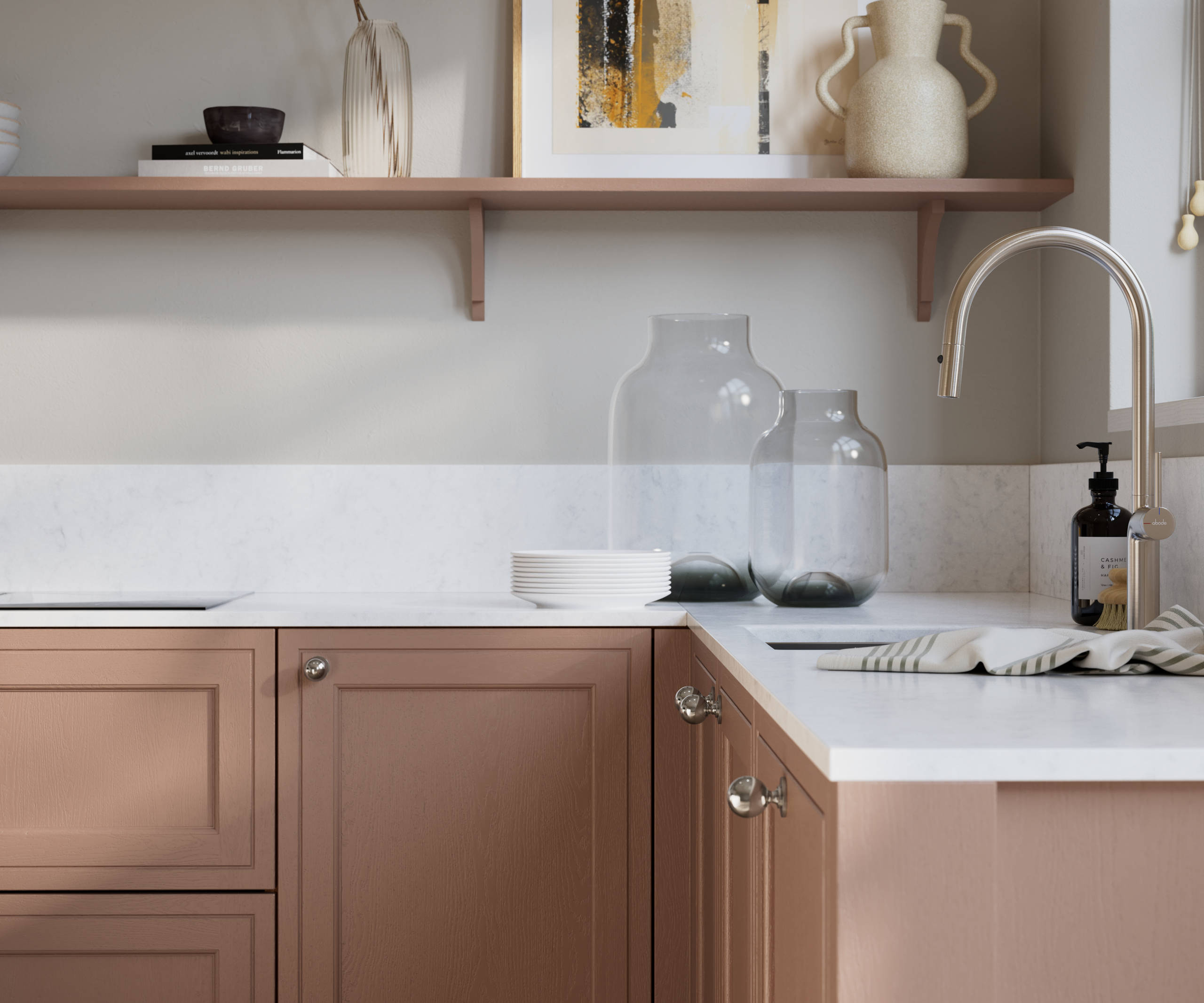 Bewdley Baked Clay painted wood grain Shaker kitchen cabinetry with steel knobs, steel tap, white marbled worktop and matching backsplash, an open shelf on the wall above cabinets with ceramics and a vase of flowers.