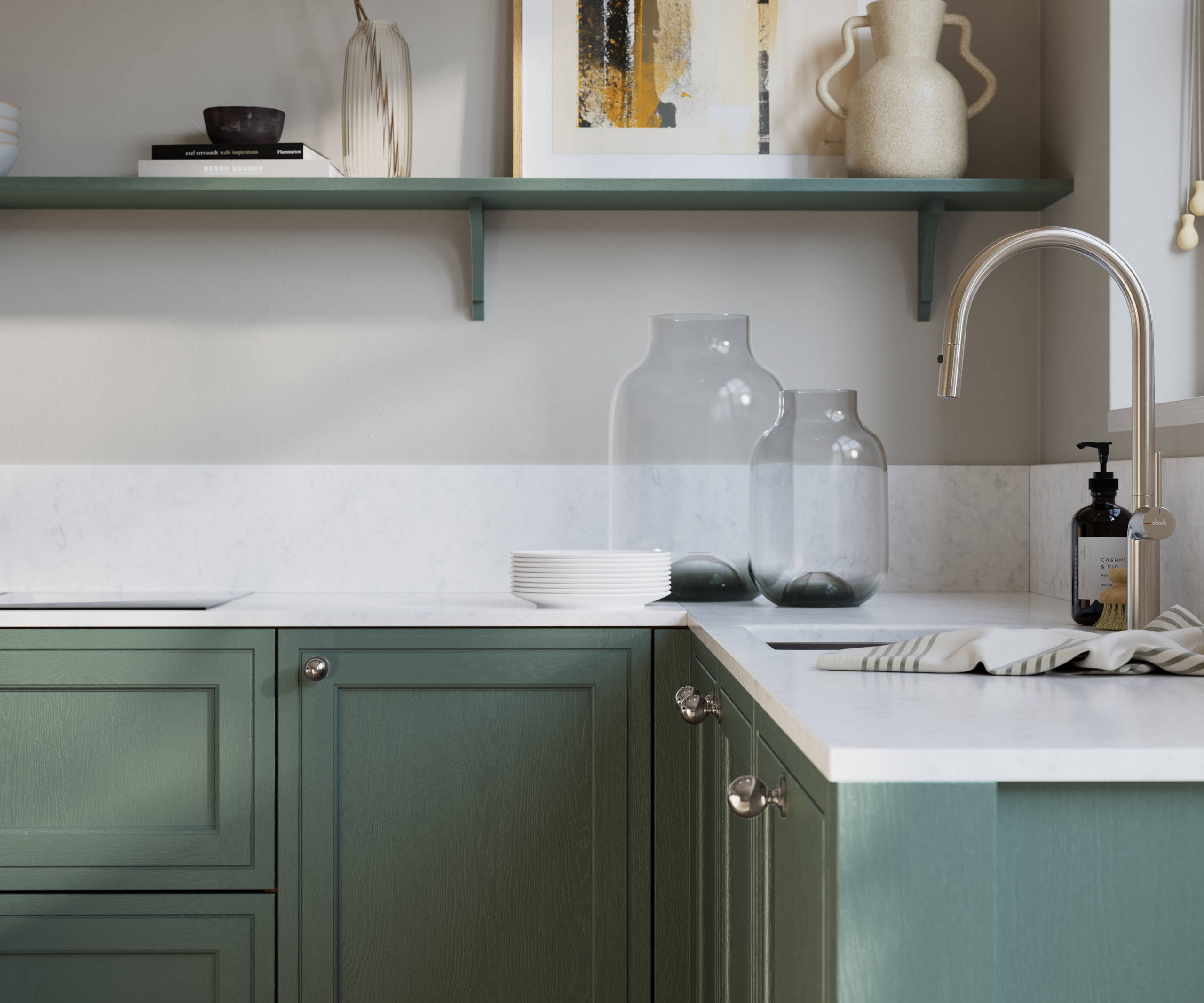 Bewdley Eucalyptus Green painted wood grain Shaker kitchen cabinetry with steel knobs, steel tap, white marbled worktop and matching backsplash, an open shelf on the wall above cabinets with ceramics and a vase of flowers.