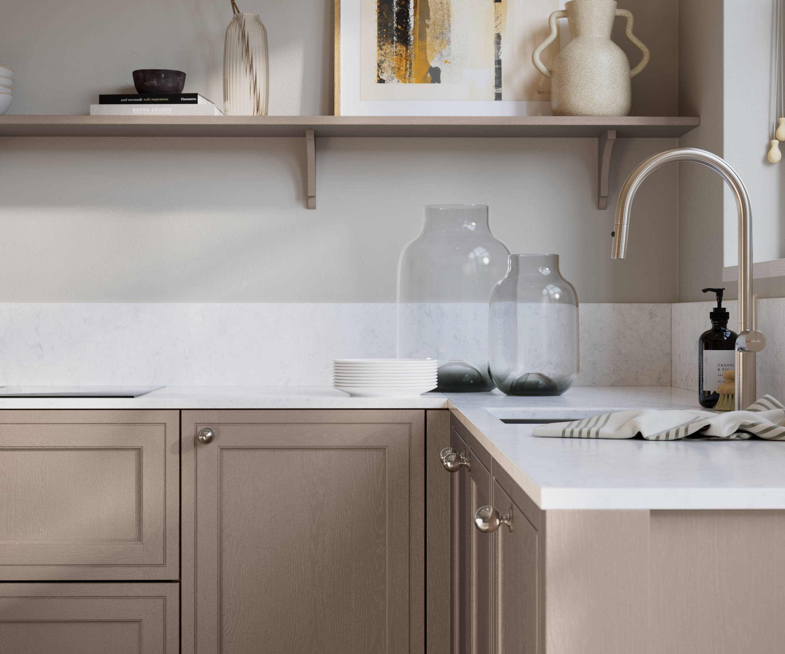 Bewdley Cornish Clay painted wood grain Shaker kitchen cabinetry with steel knobs, steel tap, white marbled worktop and matching backsplash, an open shelf on the wall above cabinets with ceramics and a vase of flowers.