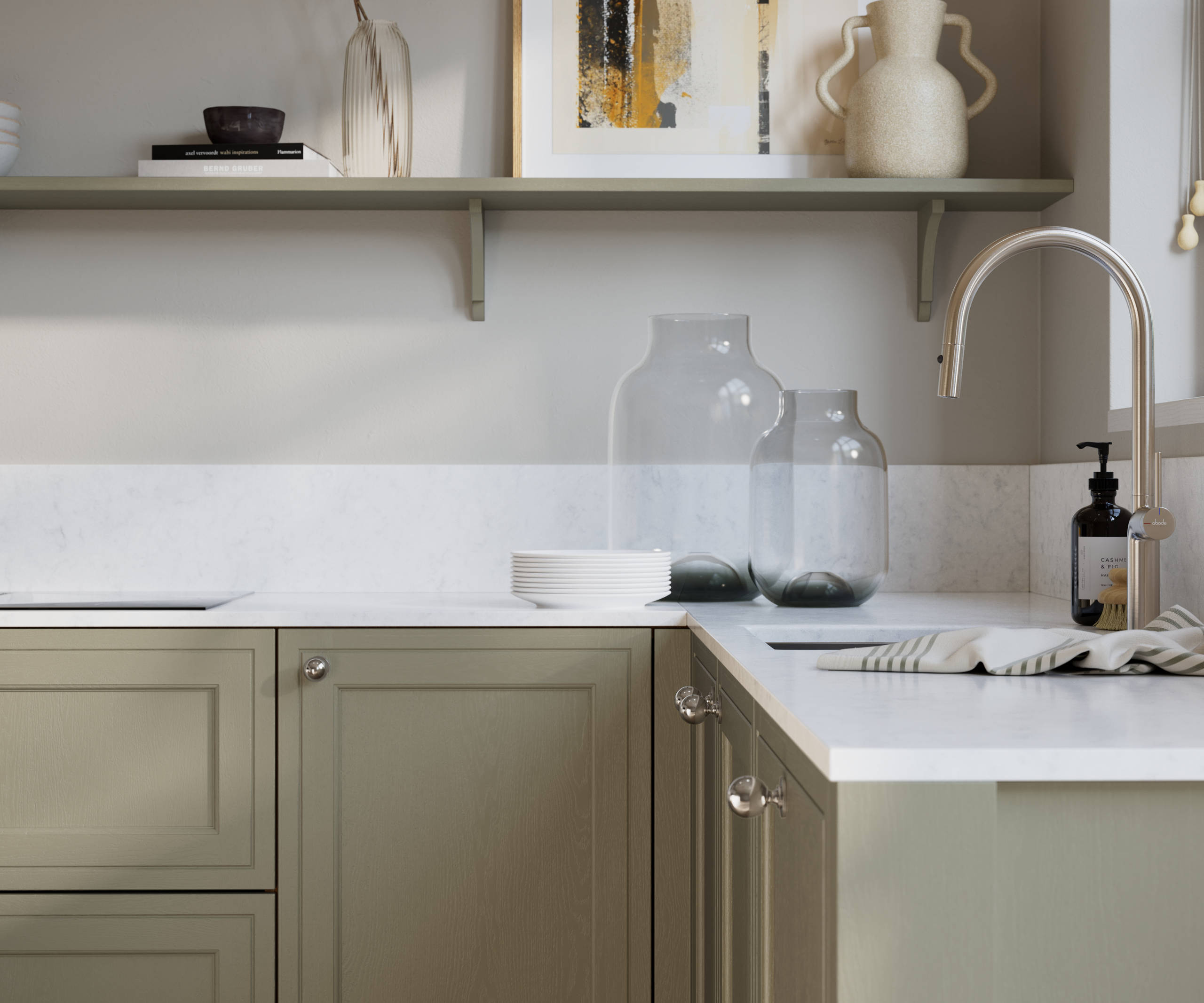Bewdley French Clay painted wood grain Shaker kitchen cabinetry with steel knobs, steel tap, white marbled worktop and matching backsplash, an open shelf on the wall above cabinets with ceramics and a vase of flowers.