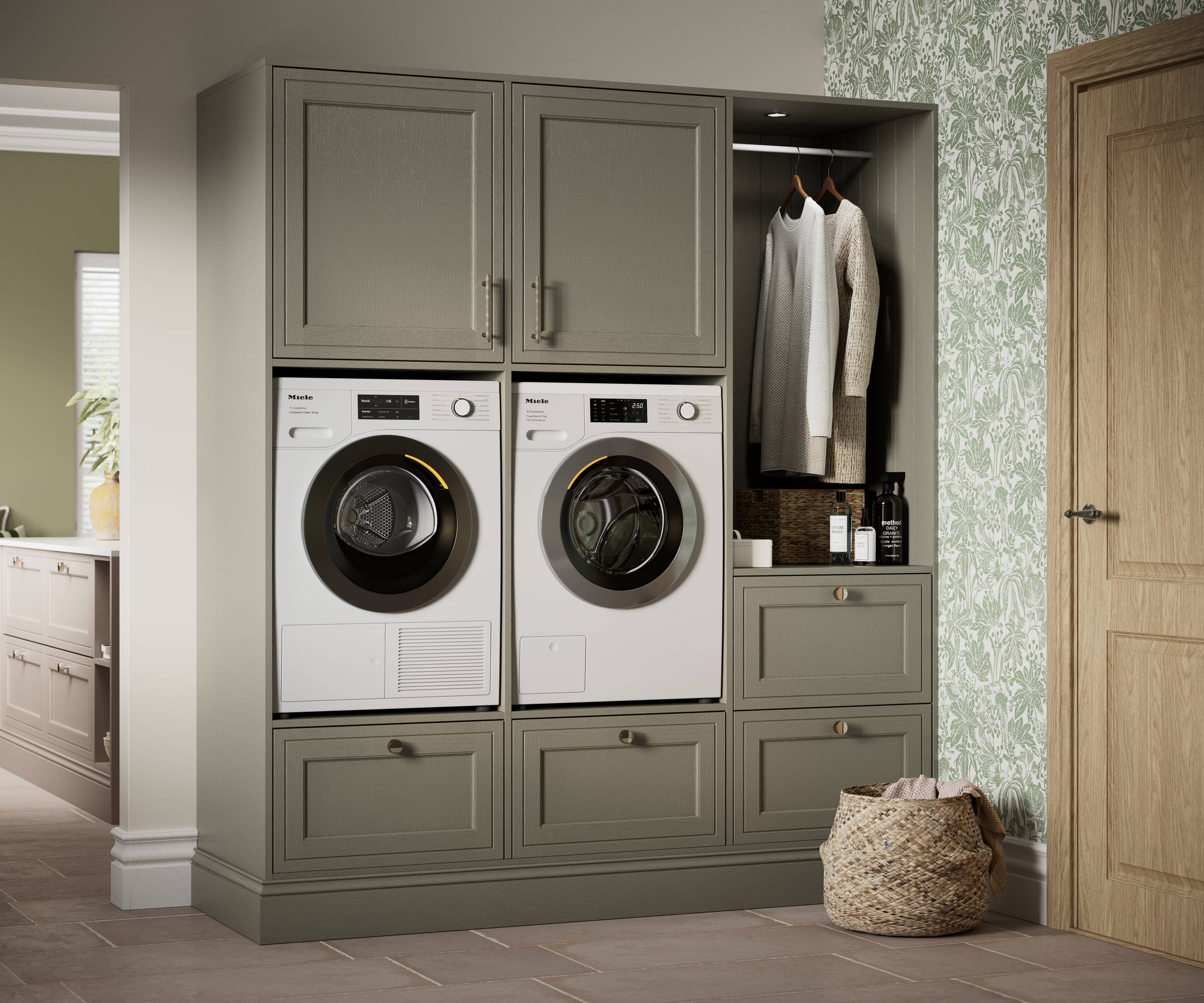Shaker style painted wood grain cabinets Bewdley cabinetry laundry room, tall cabinets with built-in washing machine and tumble dryer in green shade Balmoral.