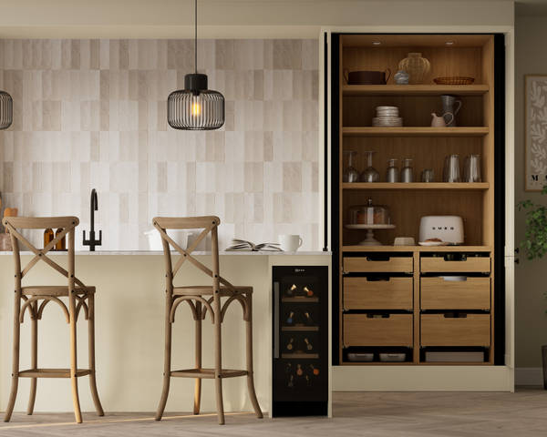 Contemporary Shaker kitchen Ambleside from Magnet in neutral shade Sand with black sink and tap in kitchen island, opened tall cabinet pocket door larder, wine cooler in kitchen island.