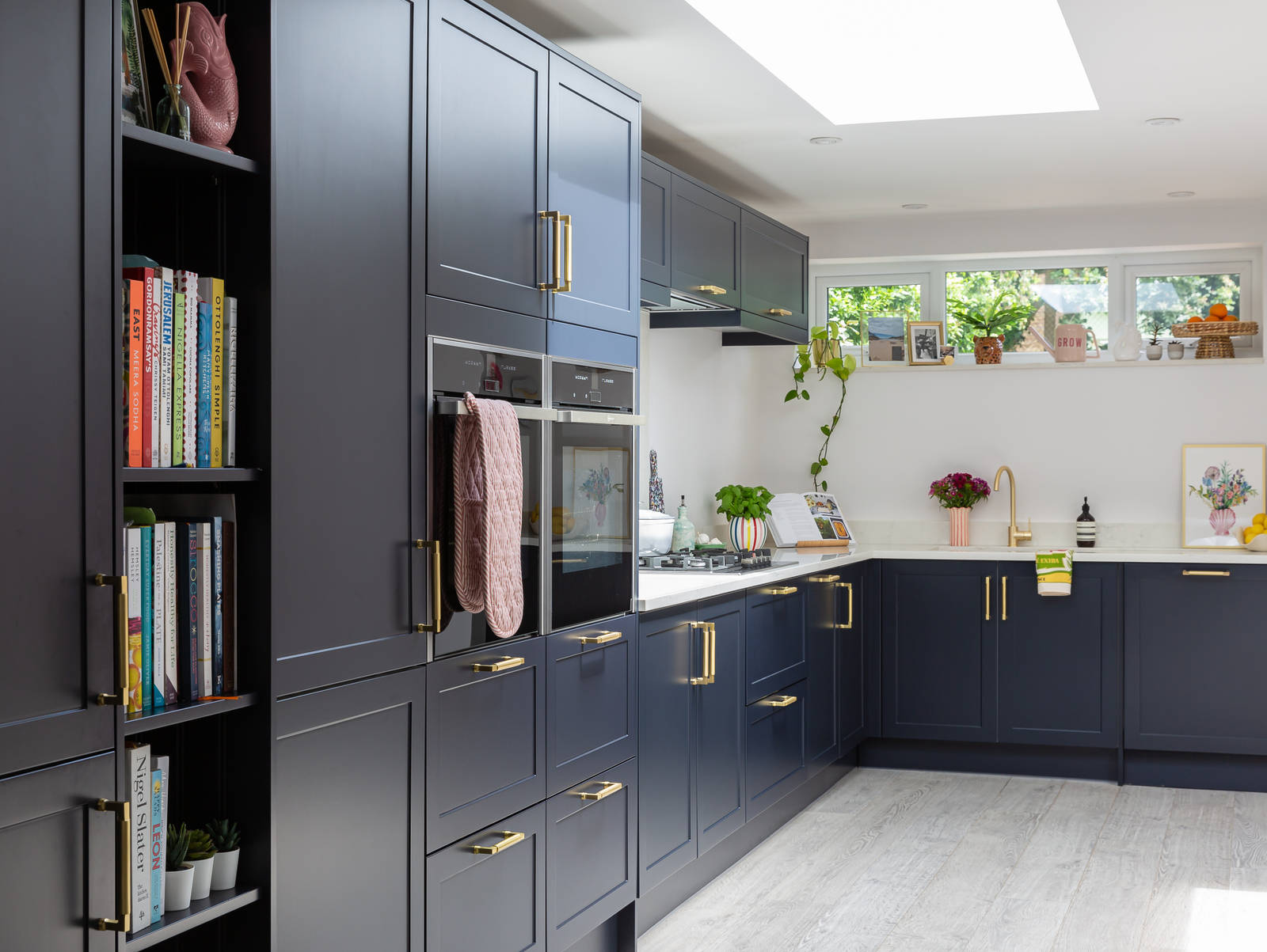 Blue shaker kitchen from Magnet with brass handles and light worktop
