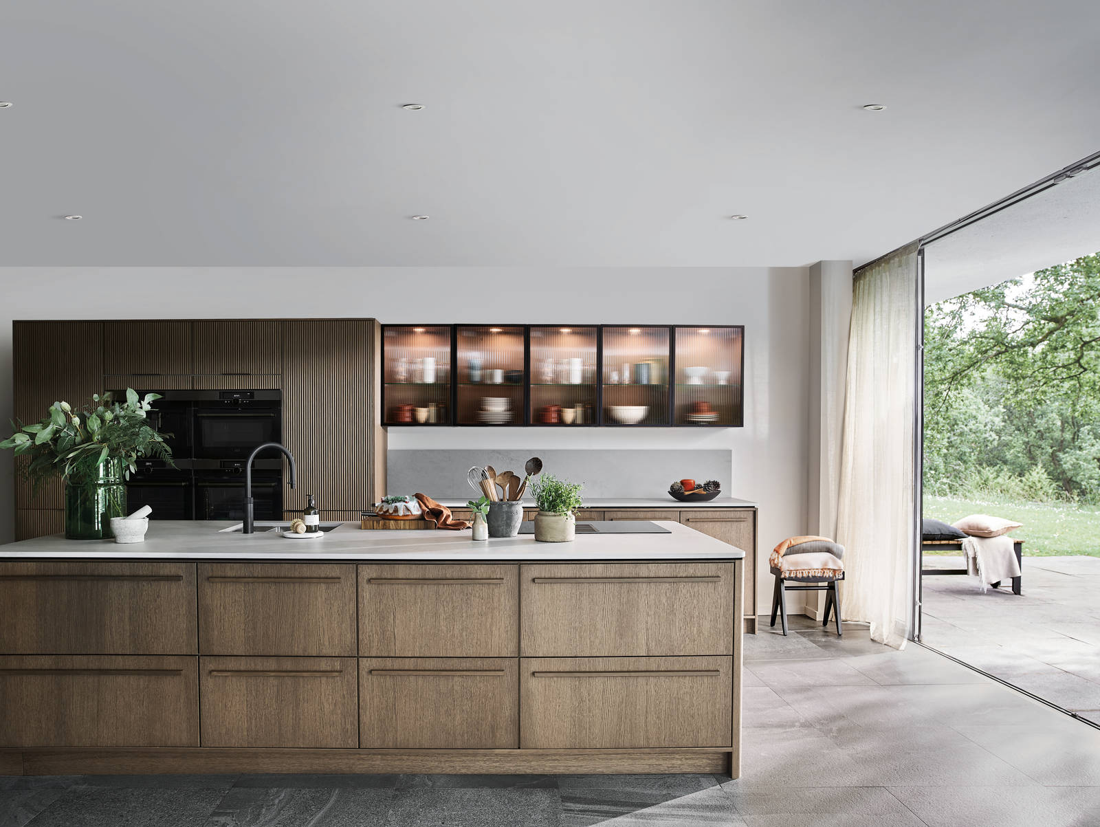 Nordic Nature. Modern wooden kitchen design with a Nordic influence. Featured floating worktops, a ribbed plinth and rounded end panels