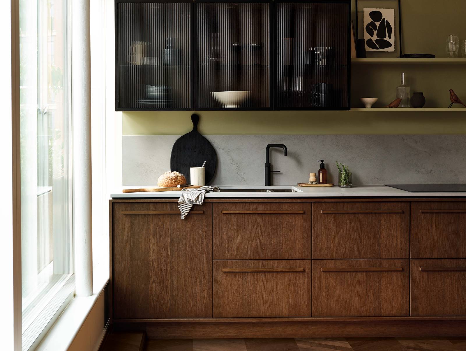 Magnet's kitchen Nordic Nature, with oak cabinetry and display cabinets with fluted glass.