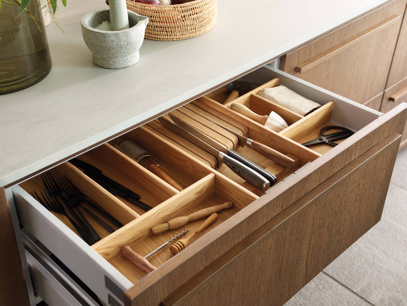 Opened drawer with oak inserts in Nordic Nature kitchen from Magnet