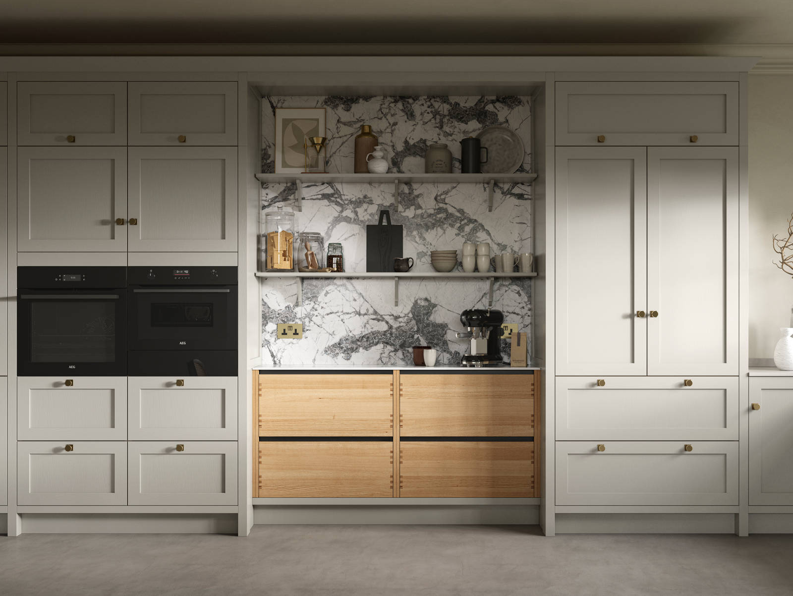 A neutral Shaker kitchen with Pebble and Nordic Craft cabinetry, marble splashback behind open shelves and paired with brass handles.