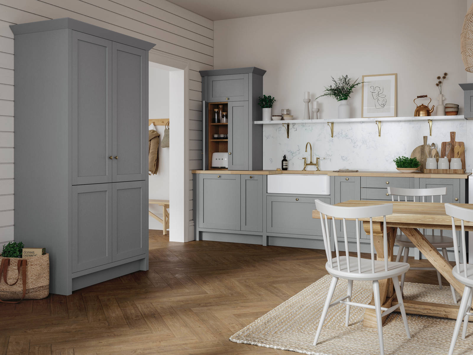 A grey Shaker Ambleside kitchen with a traditional wooden dining table and wooden flooring.