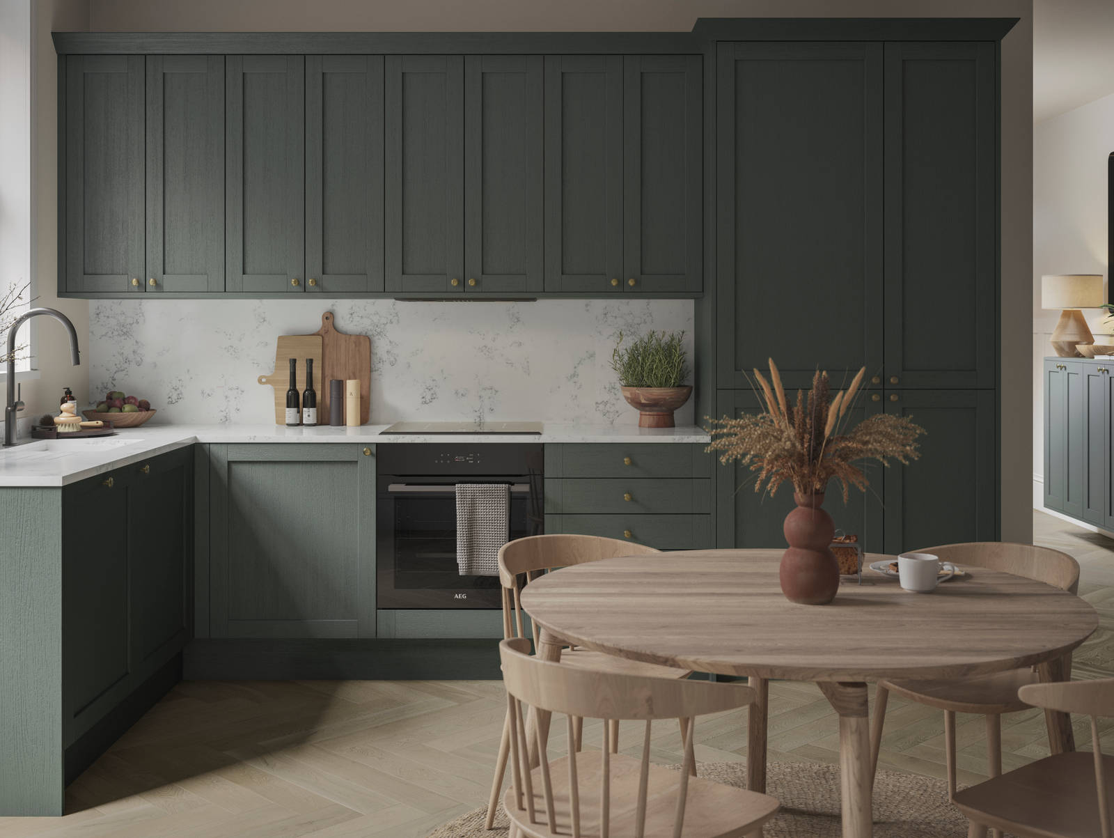 A Shaker kitchen with dark green cabinets and a wooden table.