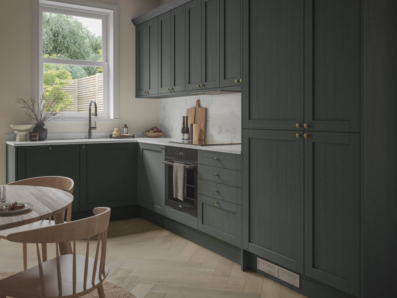 A contemporary Shaker kitchen in Ambleside with dark green cabinets and a wooden table.