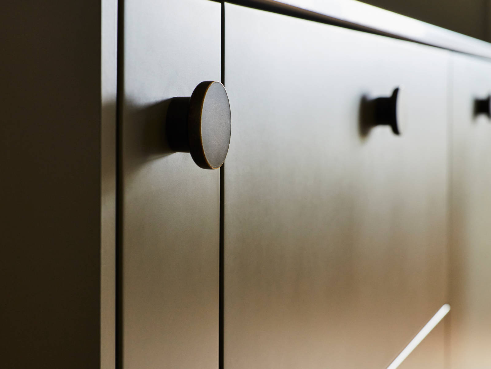 Close-up of Soho Balmoral cabinets with black circle handles