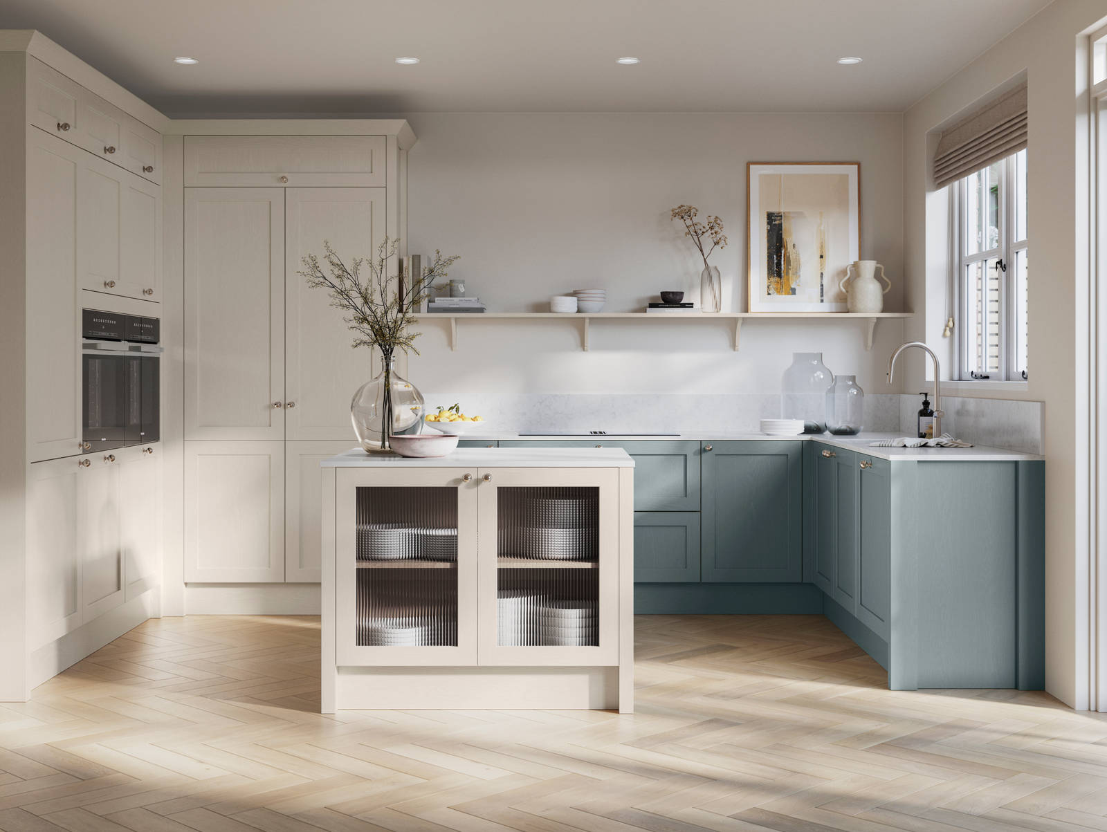 Open floorplan kitchen with small kitchen island in Wardley kitchen from Magnet in the light shade Limestone as well as blue Duck egg, decorated with flowers in glass vases and earth toned ceramics.