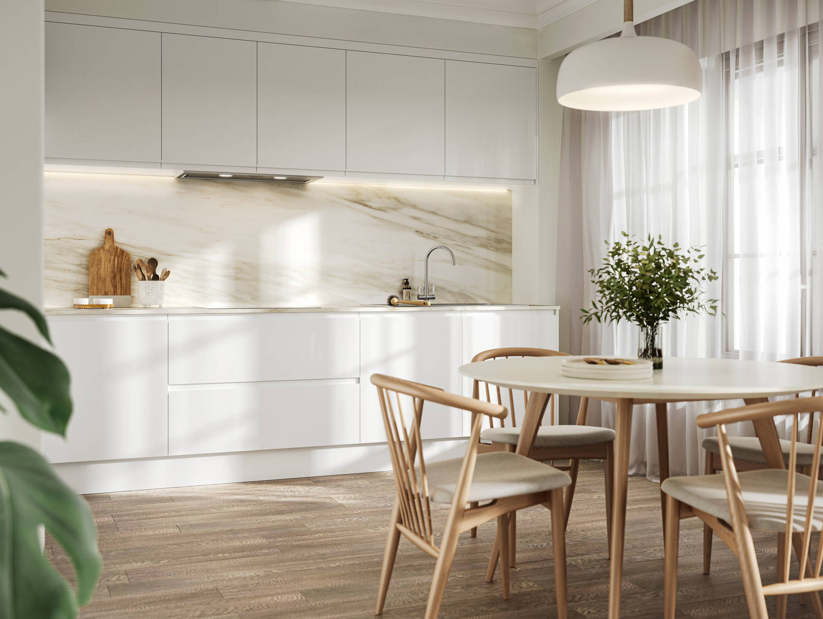 Handleless white gloss Luna kitchen from Magnet, a round wooden kitchen table with matching chairs in foreground