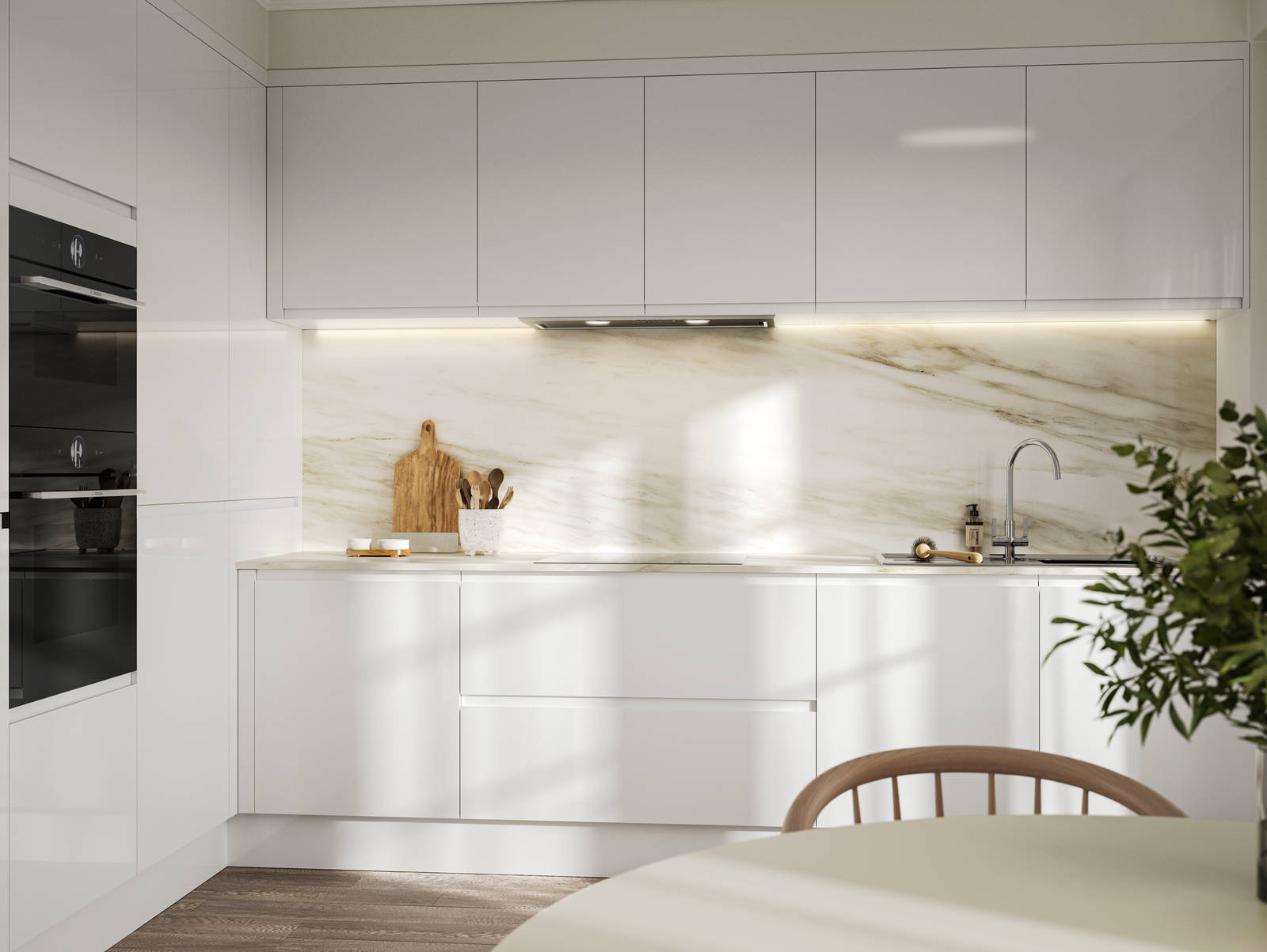 Handleless white gloss Luna kitchen from Magnet, with a white marbled worktop and backsplash.