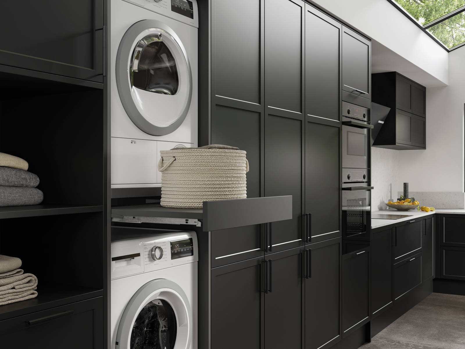 Pulled out drawer between laundry machine and dryer to serve as a shelf in black modern shaker Brunswick kitchen and laundry room