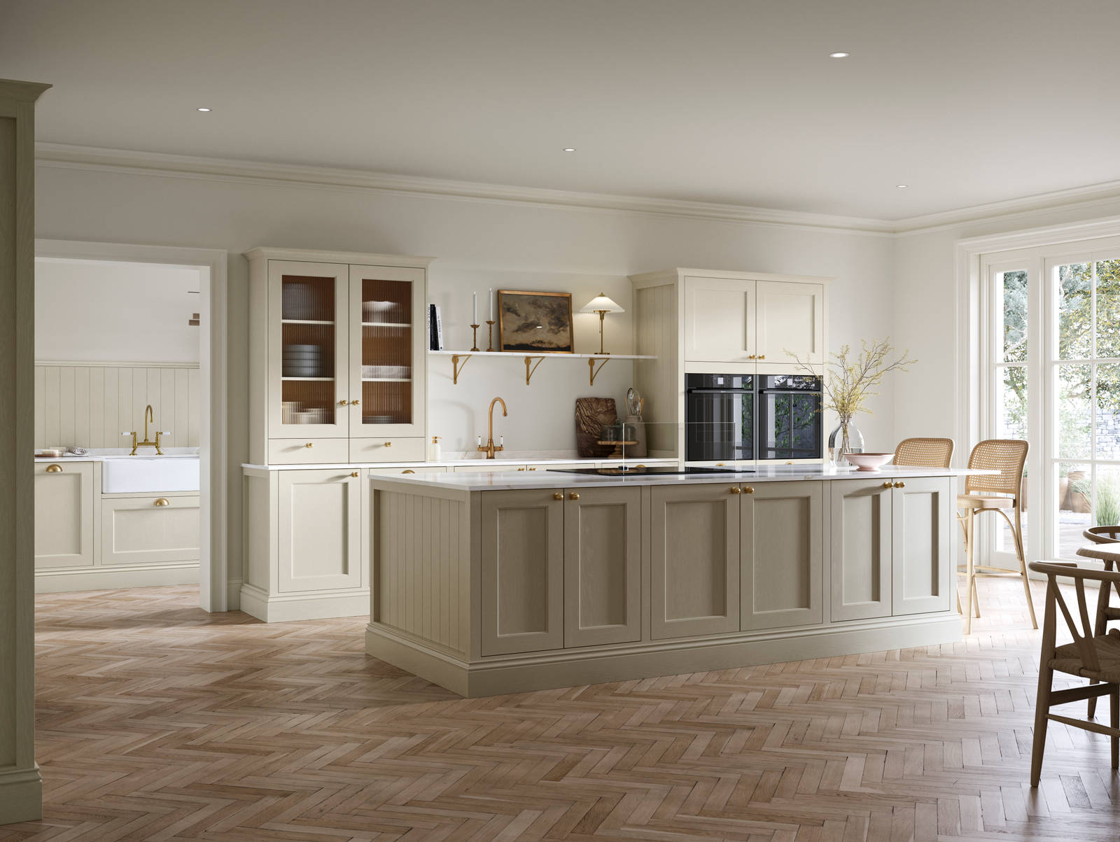 Open plan living room and Traditional Shaker-style kitchen Ludlow Parchment with tactile woodgrain, flute glass vitrine cabinets,  brass acessories like handles and tap, integrated ovens, a kitchen island and light wood herringbone flooring.