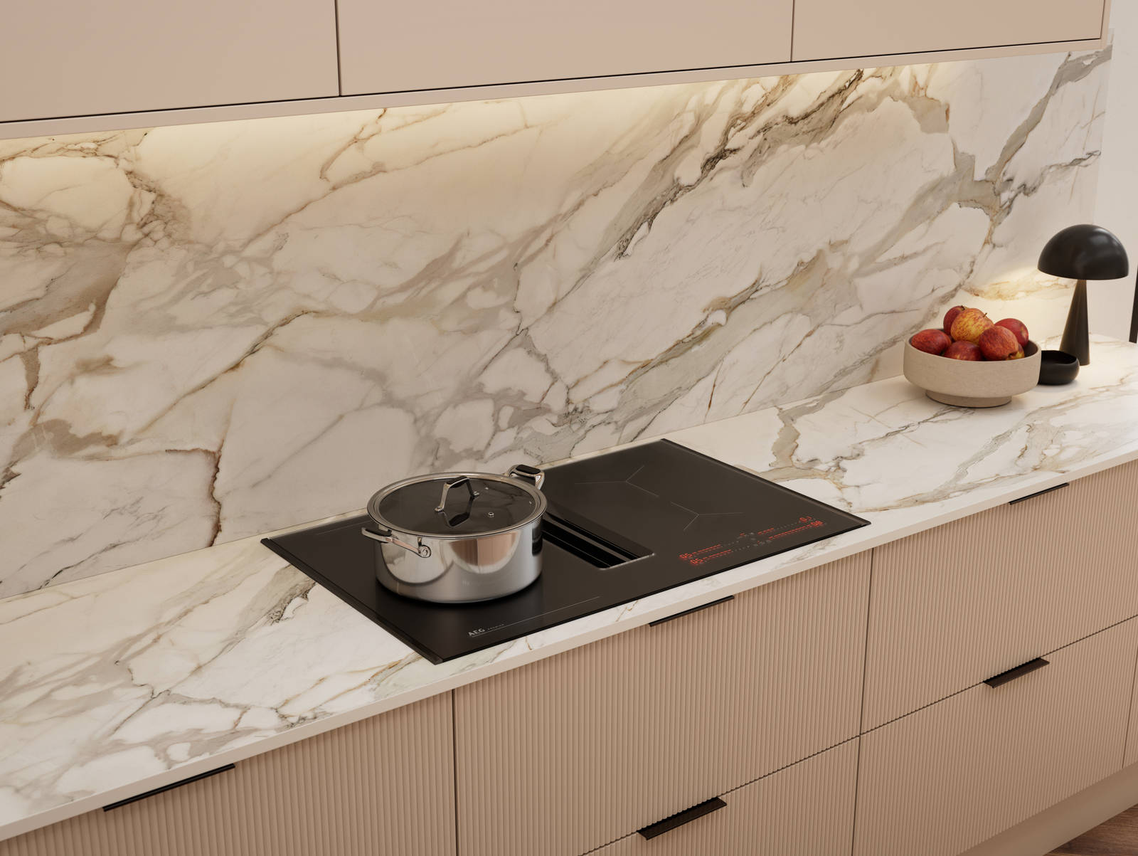 Fluted front kitchen Reed from Magnet in light warm neutral shade Shell, with a marbled splashback and worktop, induction hob and black handles
