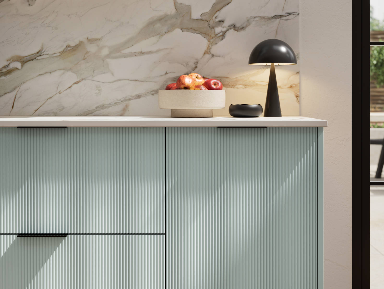 Fluted front kitchen Reed from Magnet in bright blue shade Sky, with a marbled splashback and black handles, herringbone wood flooring.