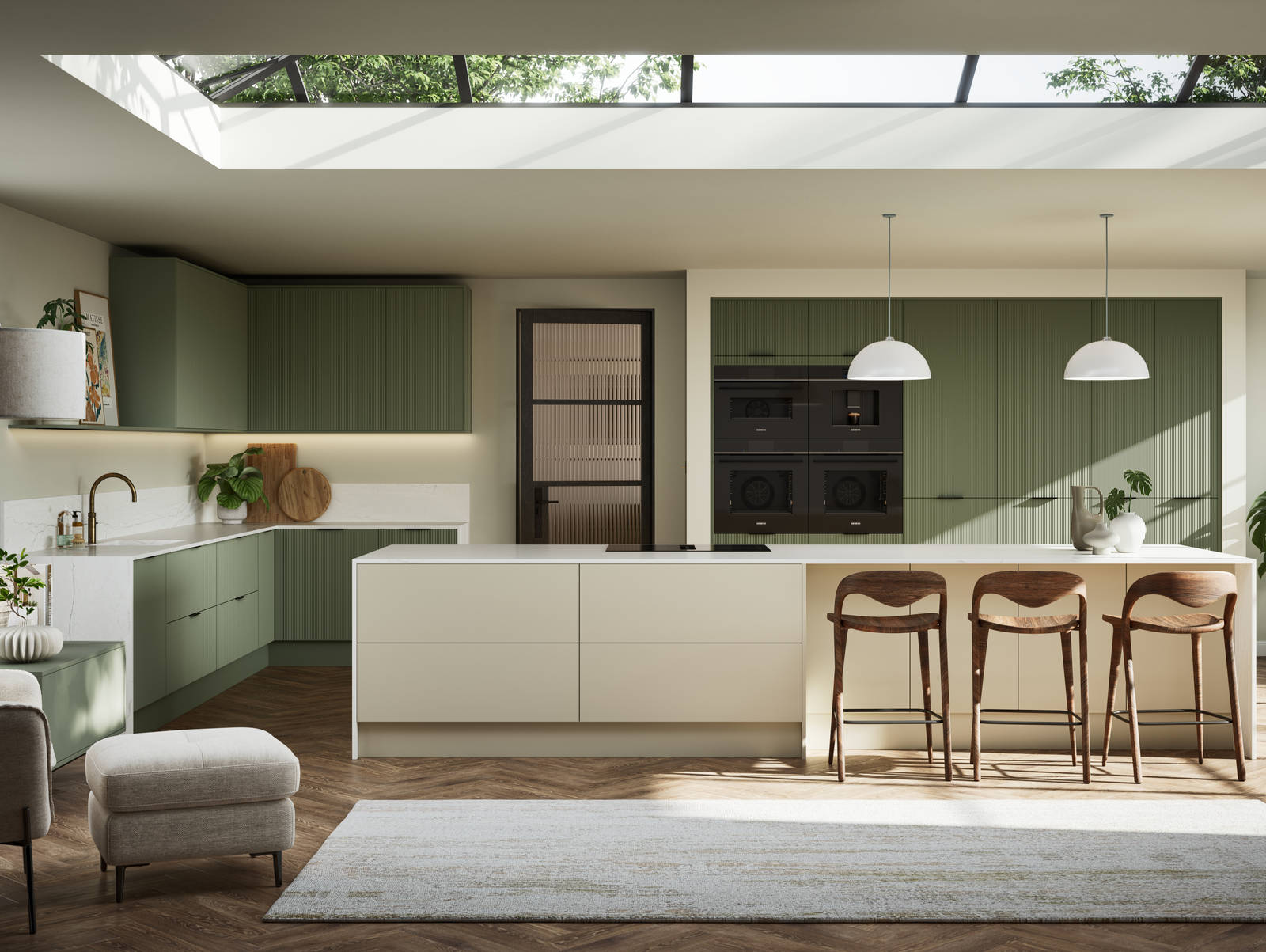 Green fluted kitchen fronts on tall cabinets with built-in appliances and black handles, light neutral shade kitchen island with white worktop and wooden barstools.
