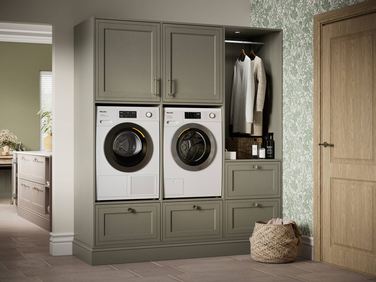 Shaker style painted wood grain cabinets Bewdley cabinetry laundry room, tall cabinets with built-in washing machine and tumble dryer in green shade Balmoral.