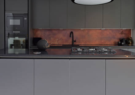 View of kitchen island with black granite worktop, gas hob and Elica HD seashell hood in black in the ultra-contemporary integra soho charcoals