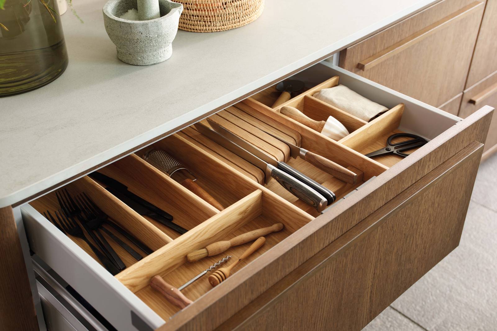 Opened drawer with oak inserts in Nordic Nature kitchen from Magnet