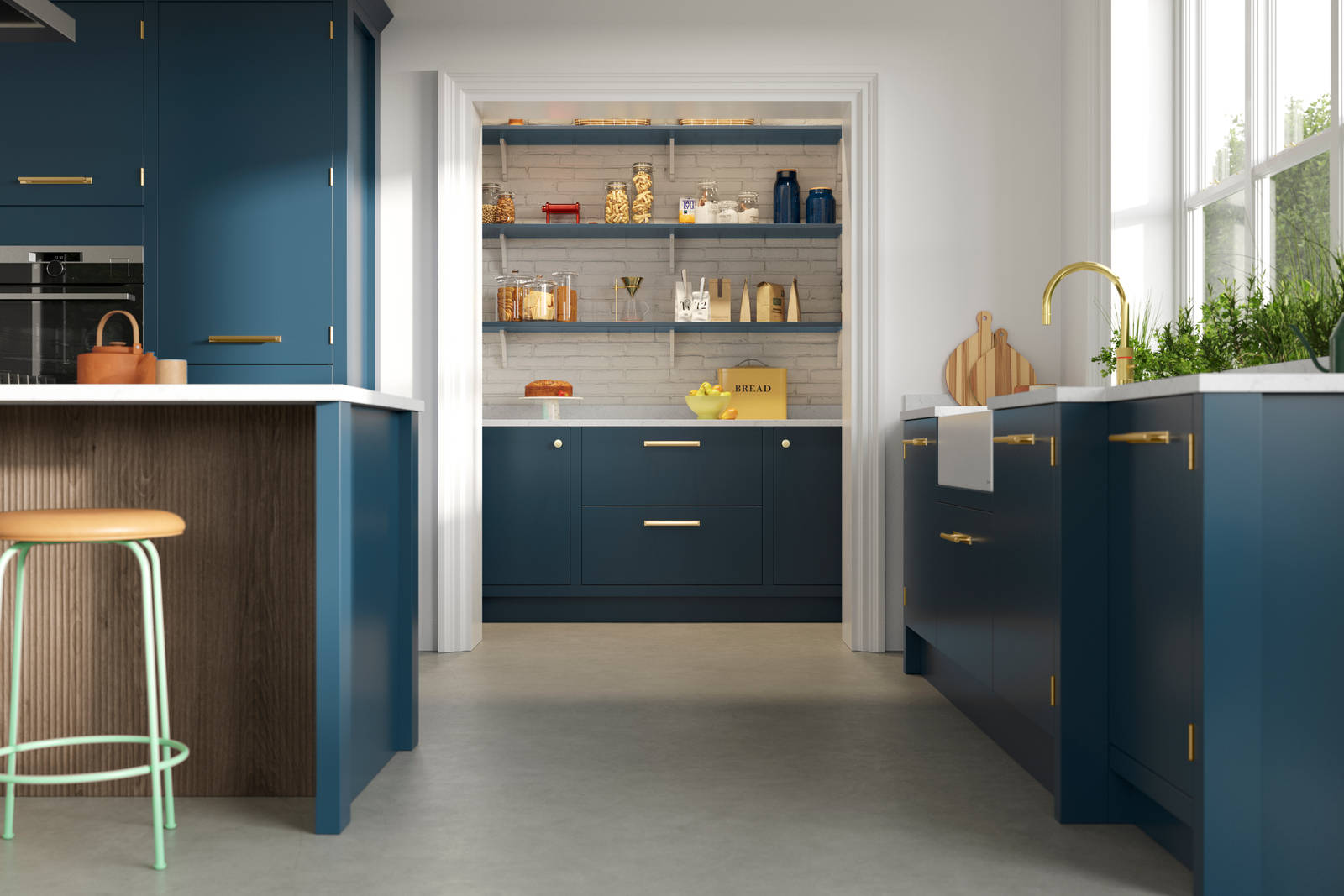 View of Soho Voyage Blue kitchen with brass accent details and pantry.