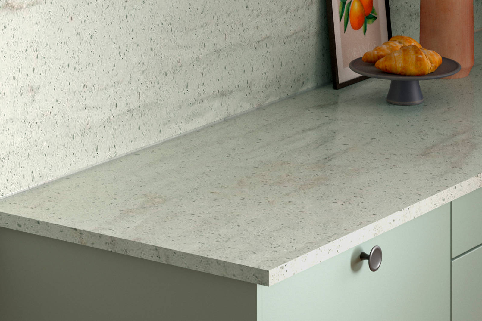 Concrete worktop in Soho Seagrass kitchen with black knobs