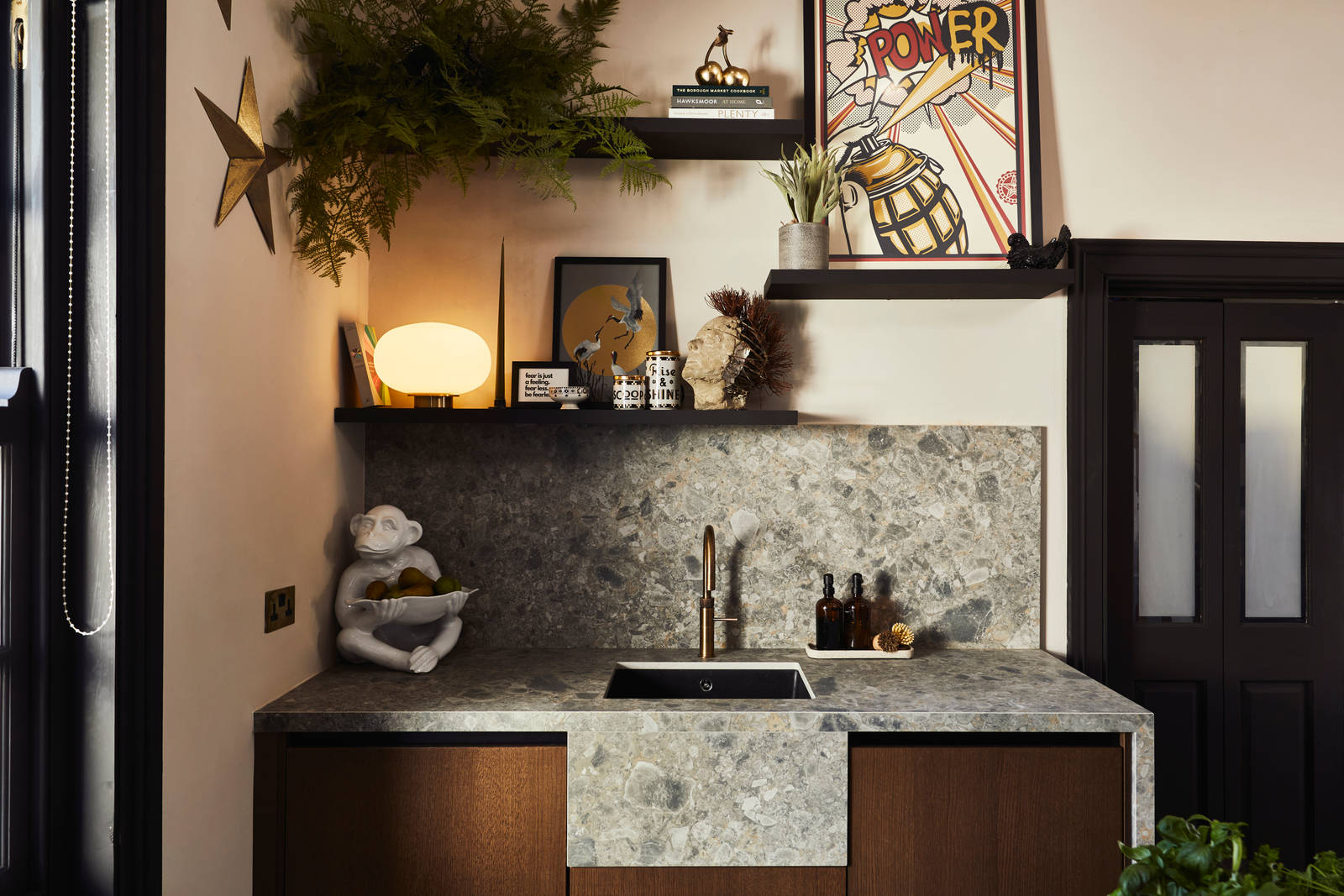 Sink area with Dekton in Ceppo backsplash and worktop, Nordic Nature cabinetry and a brass Quooker tap, combined with plants on open shelves on wall