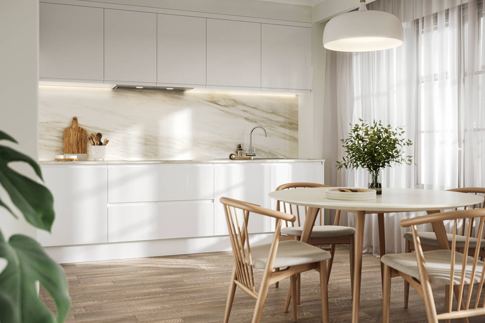 Handleless white gloss Luna kitchen from Magnet, a round wooden kitchen table with matching chairs in foreground