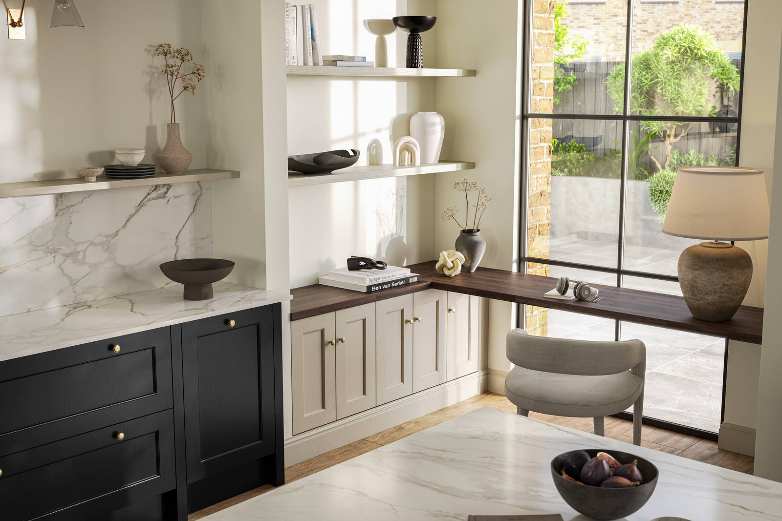 View over kitchen island in Traditional Shaker-style tactile woodgrain Ludlow Sumi Black kitchen, brass details, and dark wood worktop in home office with Ludlow French clay seating area by black metal frame full height window.
