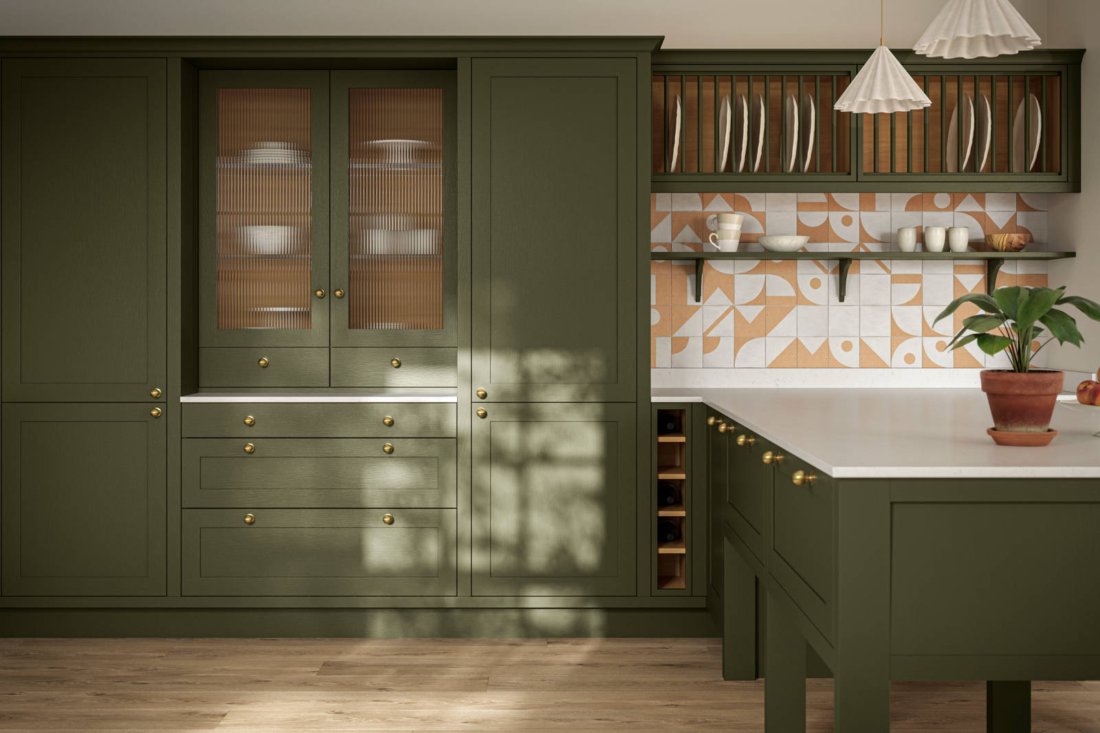 Premium Shaker kitchen Wardley Tailored green with kitchen island, traditional detailing, brass accessories, white worktop and Classic Flint Grey oiled oak engineered wood flooring.