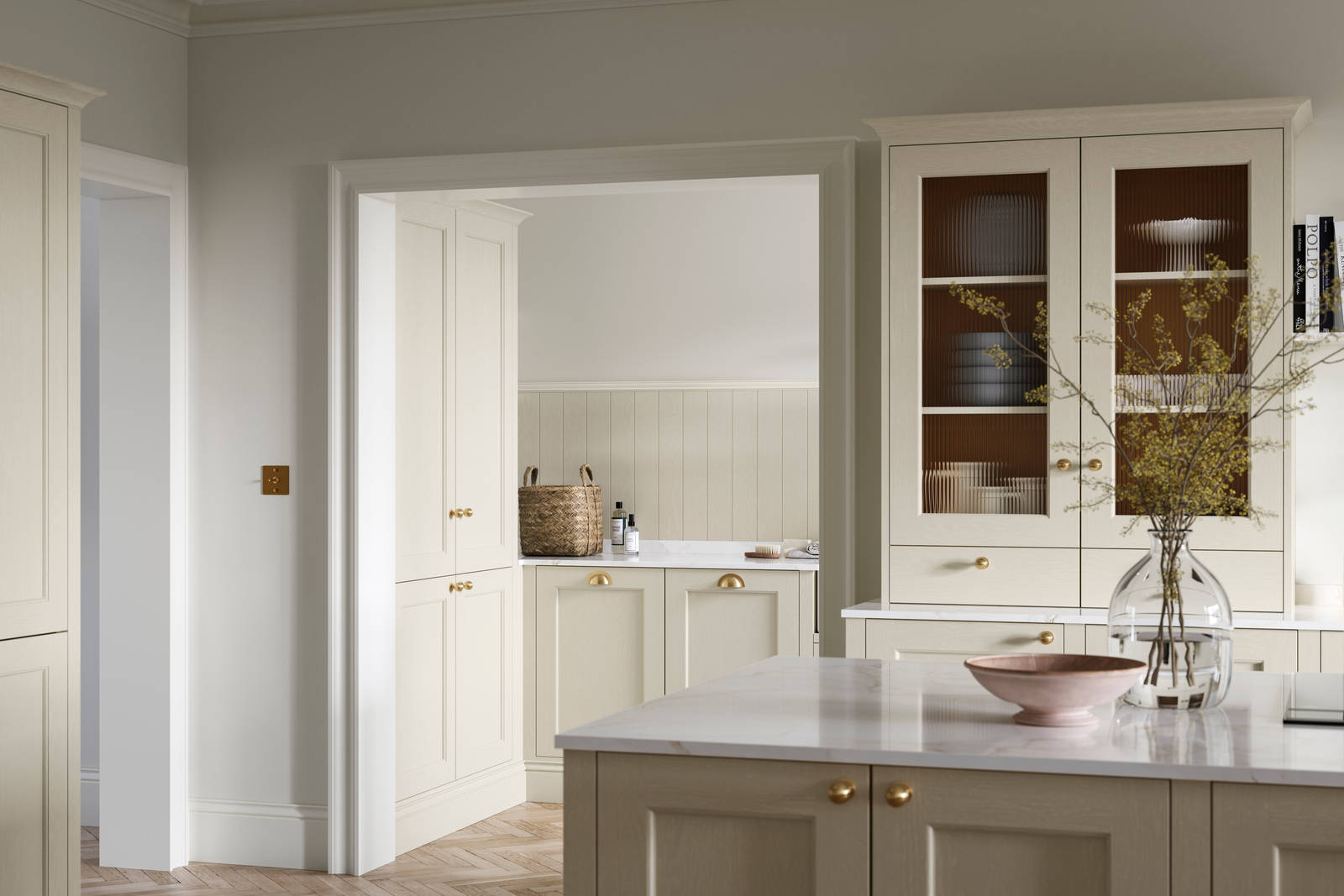 Open plan living room and Traditional Shaker-style kitchen Ludlow Parchment and view of utility room with white ceramic trough door frame, Goodrich Natural Oak herringbone engineered flooring, brass handles, brass knobs and bras tap.