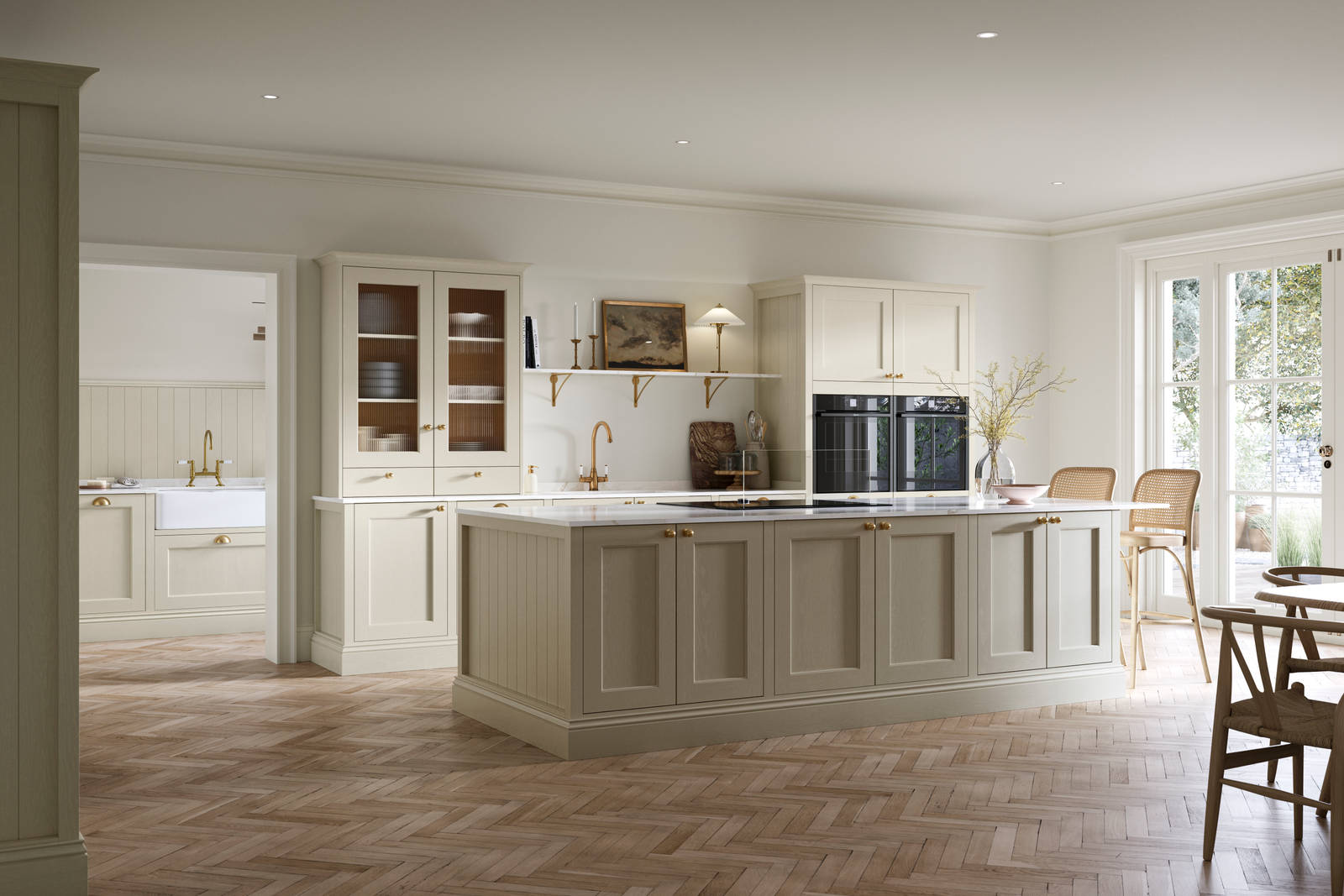 Open plan living room and Traditional Shaker-style kitchen Ludlow Parchment with tactile woodgrain, flute glass vitrine cabinets,  brass acessories like handles and tap, integrated ovens, a kitchen island and light wood herringbone flooring.