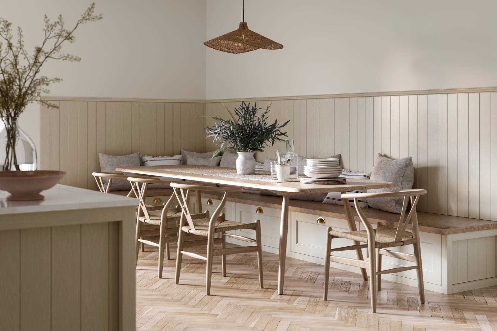 Traditional Shaker-style Ludlow Parchment bench cabinets with tactile woodgrain, a kitchen island and matching wall panel, a long wood diningroom table with matching wood chairs and ceramics set out on the table.