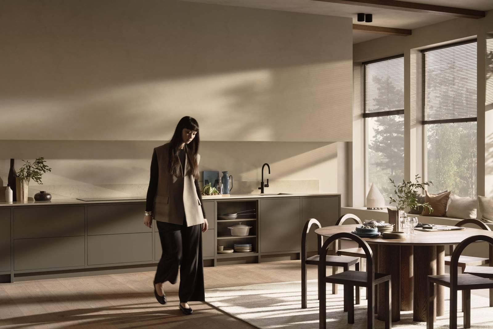 Varm minimalisme kvinde går gennem køkkenet