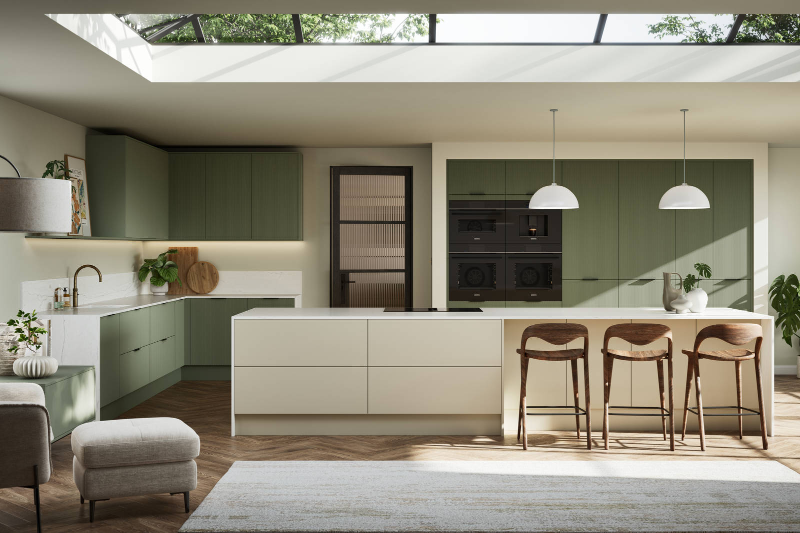 Green fluted kitchen fronts on tall cabinets with built-in appliances and black handles, light neutral shade kitchen island with white worktop and wooden barstools.