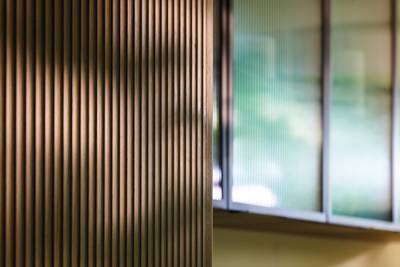 View of fluted wood front with display cabinetry in the background.