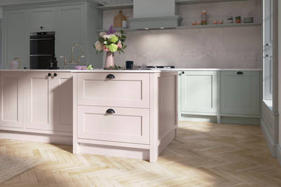 Ludlow, a traditional Shaker-style kitchen range featuring panelled doors with visible woodgrain and beading detail, in the light airy shade Seagrass.