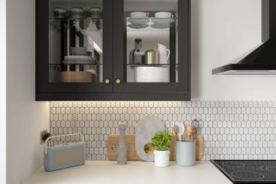 Close-up of framed glass front display cabinets Tatton Midnight kitchen from Magnet, a contemporary dark blue narrow frame shaker door.