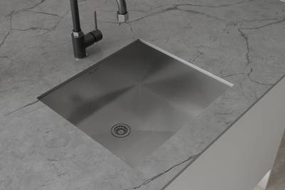 Overhead vire of matt black tap and square sink on grey Integra Nova kitchen island with marbled grey worktop.