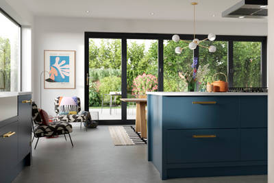View of kitchen island in Soho Voyage Blue kitchen  with brass handles.
