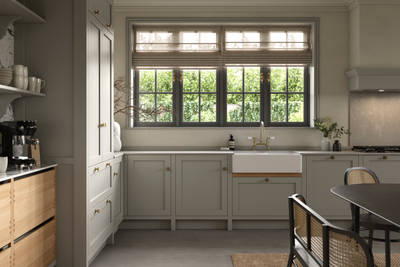 A neutral Shaker kitchen with Pebble and Nordic Craft cabinetry, belfast sink and traditional style tap.