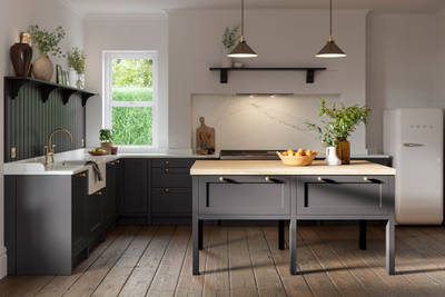 A dark grey Shaker kitchen with Charcoals cabinetry, with a kitchen island covered with a wooden worktop.