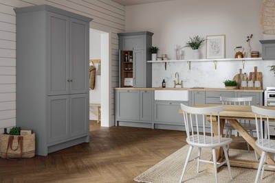 A grey Shaker Ambleside kitchen with a traditional wooden dining table and wooden flooring.