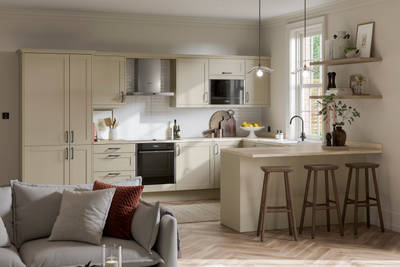 Tatton Sage from Magnet, a contemporary narrow frame shaker door, with a grey sofa in the foreground